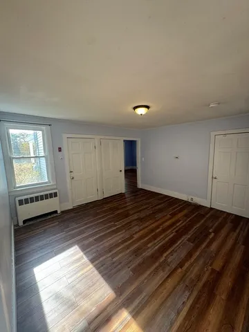 a view of a room with wooden floor and a sink