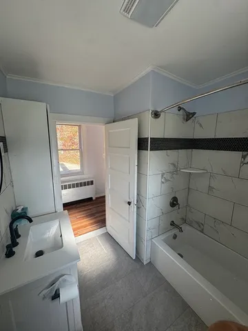 a bathroom with a tub toilet and a sink