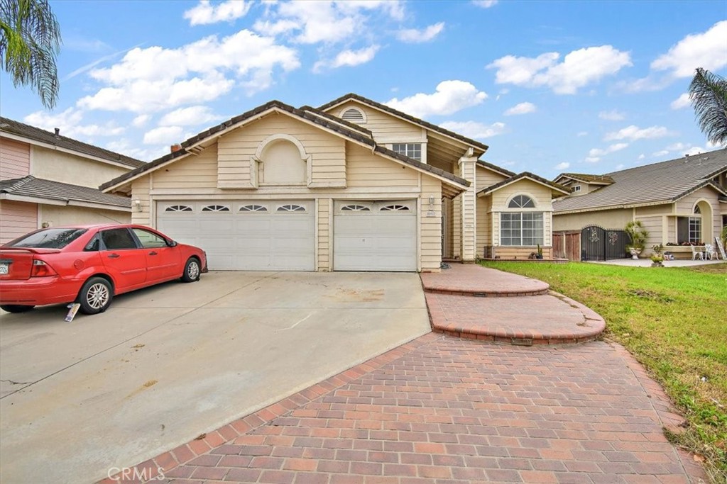 8052 Wendover Drive Riverside, CA 92509 - Photo 1 of 1 a front view of a house with a garden