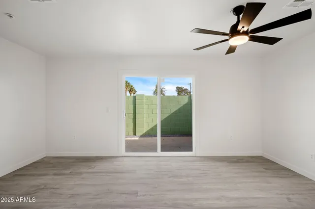 a view of a room with a ceiling fan