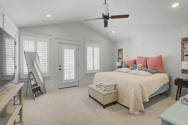 a spacious bedroom with a bed and a large window