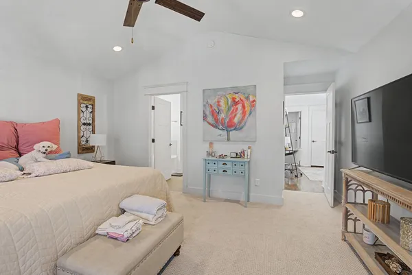a bedroom with furniture and a flat screen tv