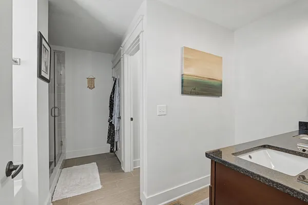 a bathroom with a granite countertop sink toilet and shower