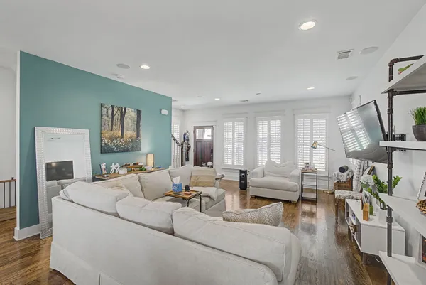 a living room with fireplace furniture and a wooden floor