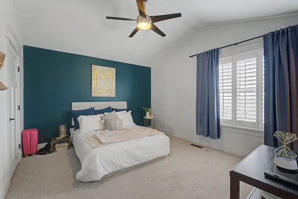 a bedroom with a bed and a chandelier