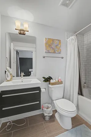 a bathroom with a sink mirror vanity and toilet