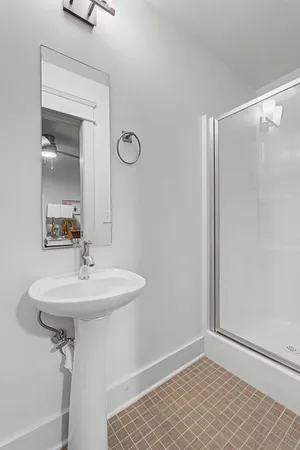 a bathroom with a sink mirror and vanity