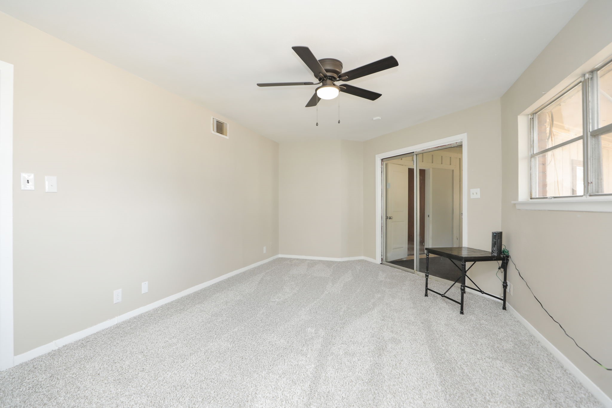 8235 Dover Street Houston, TX 77061 - Photo 26 of 36 a view of a livingroom with a ceiling fan and wooden floor