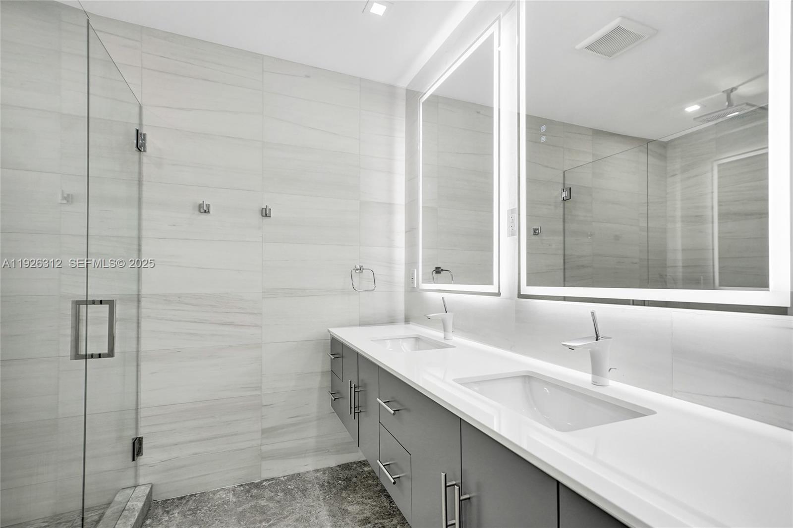 200 Sunrise Drive, Unit 200A Key Biscayne, FL 33149 - Photo 11 of 45 a bathroom with a double vanity sink and mirror