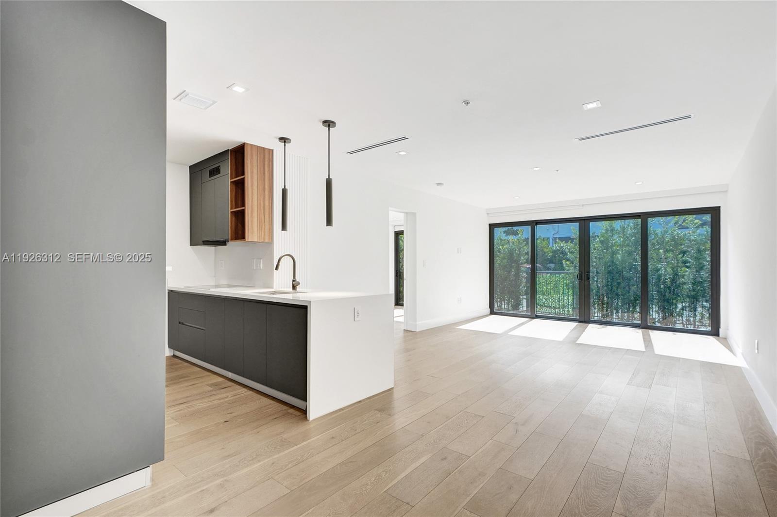 200 Sunrise Drive, Unit 200A Key Biscayne, FL 33149 - Photo 13 of 45 a view of an empty room with wooden floor and a window