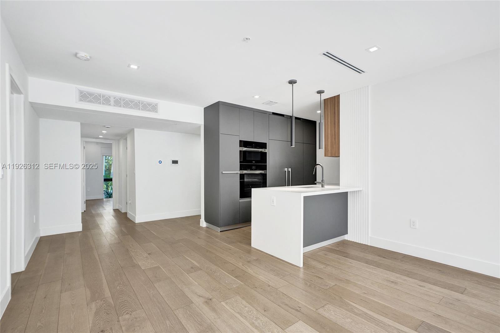 200 Sunrise Drive, Unit 200A Key Biscayne, FL 33149 - Photo 14 of 45 a view of a kitchen with wooden floor and a sink