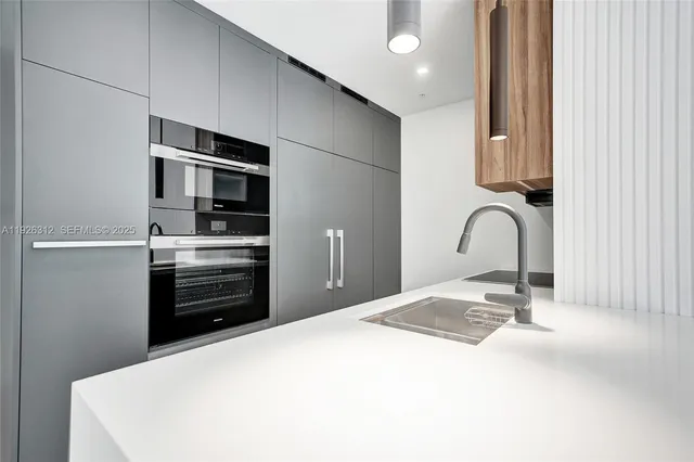 an empty room with wooden floor and bathroom