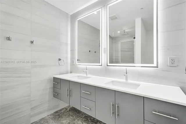 a bathroom with a sink toilet a mirror and shower