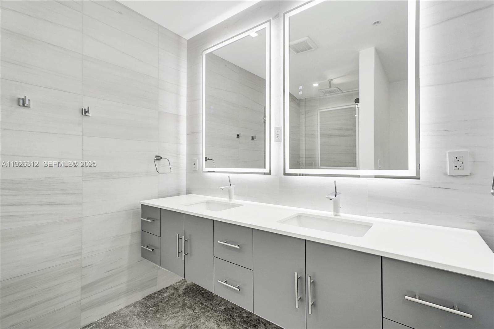 200 Sunrise Drive, Unit 200A Key Biscayne, FL 33149 - Photo 17 of 45 a bathroom with a sink and a mirror