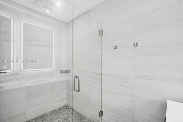 a view of a big room with wooden floor and windows