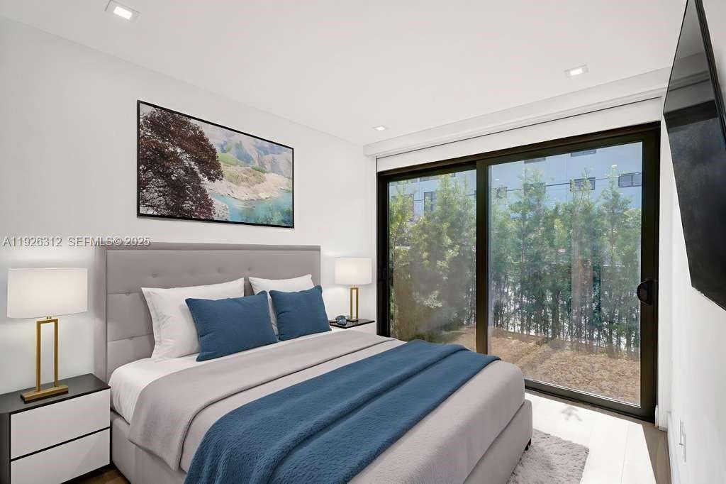 200 Sunrise Drive, Unit 200A Key Biscayne, FL 33149 - Photo 24 of 45 a bedroom with a large bed and a large window