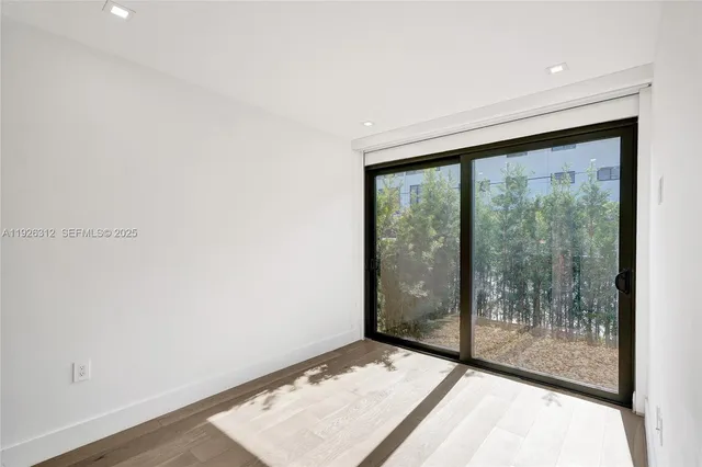 a bathroom with a shower sink vanity mirror and toilet