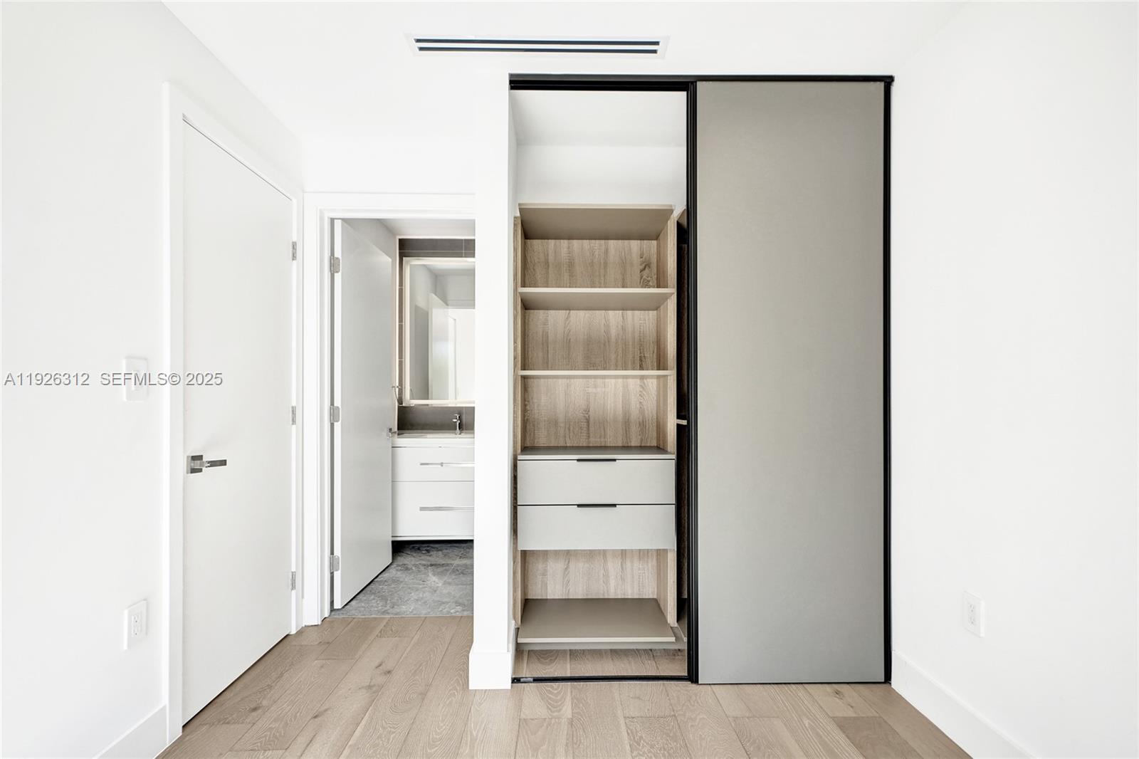 200 Sunrise Drive, Unit 200A Key Biscayne, FL 33149 - Photo 27 of 45 a view of walk in closet with empty racks