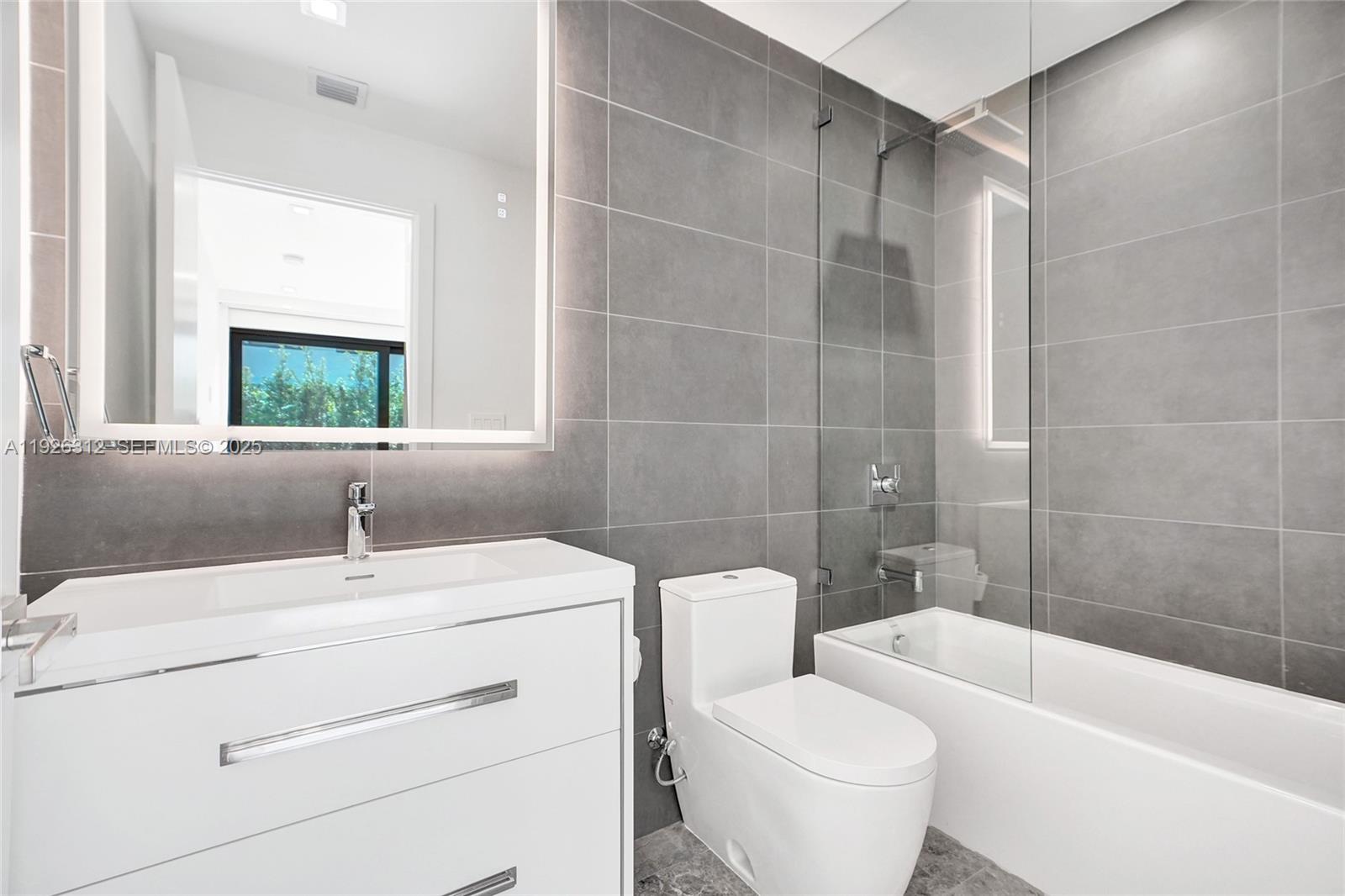 200 Sunrise Drive, Unit 200A Key Biscayne, FL 33149 - Photo 28 of 45 a bathroom with a sink toilet and shower