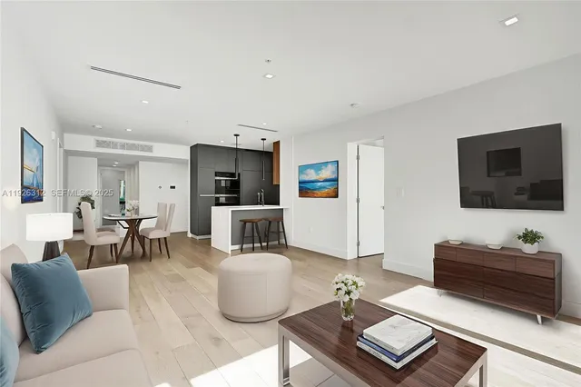 a kitchen with stainless steel appliances granite countertop a sink and dishwasher a stove top oven with wooden floor