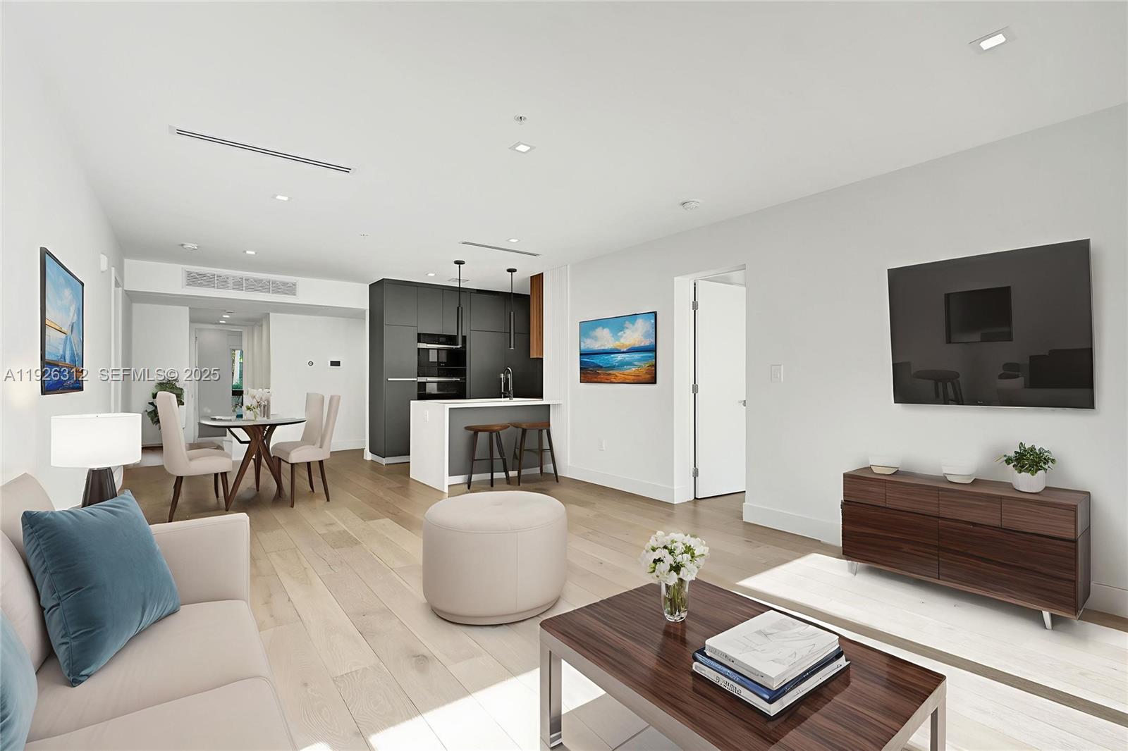 200 Sunrise Drive, Unit 200A Key Biscayne, FL 33149 - Photo 3 of 45 a living room with furniture and a flat screen tv