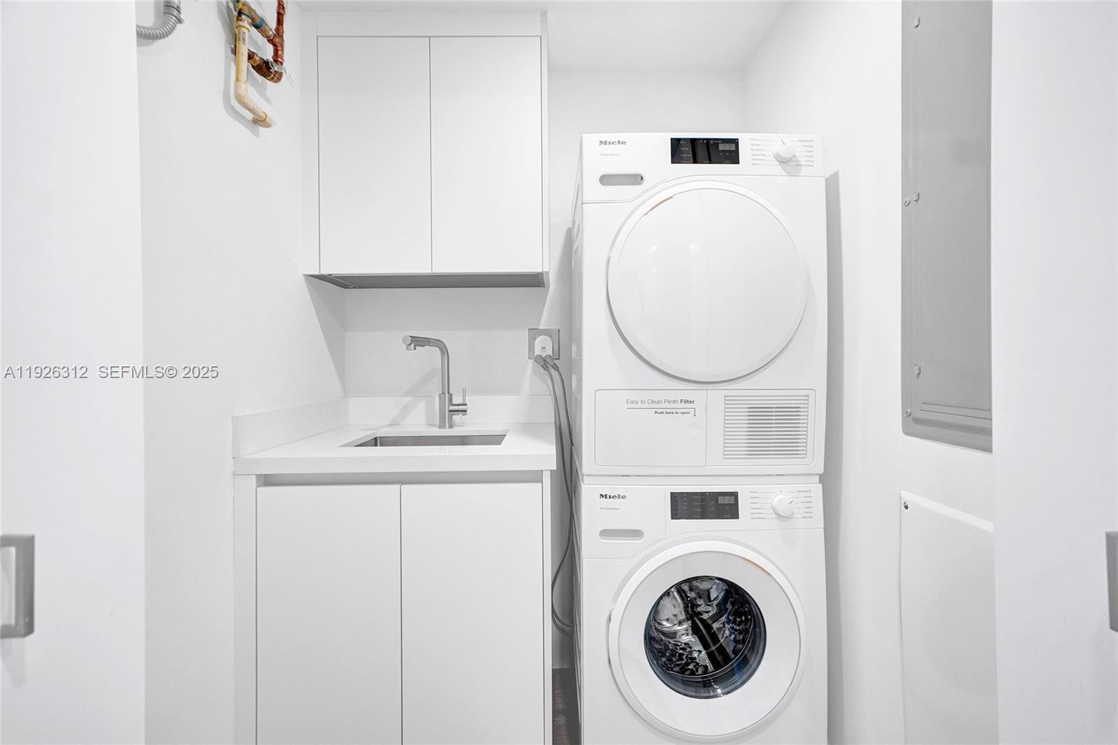 200 Sunrise Drive, Unit 200A Key Biscayne, FL 33149 - Photo 34 of 45 a close view of a utility room with dryer and washer
