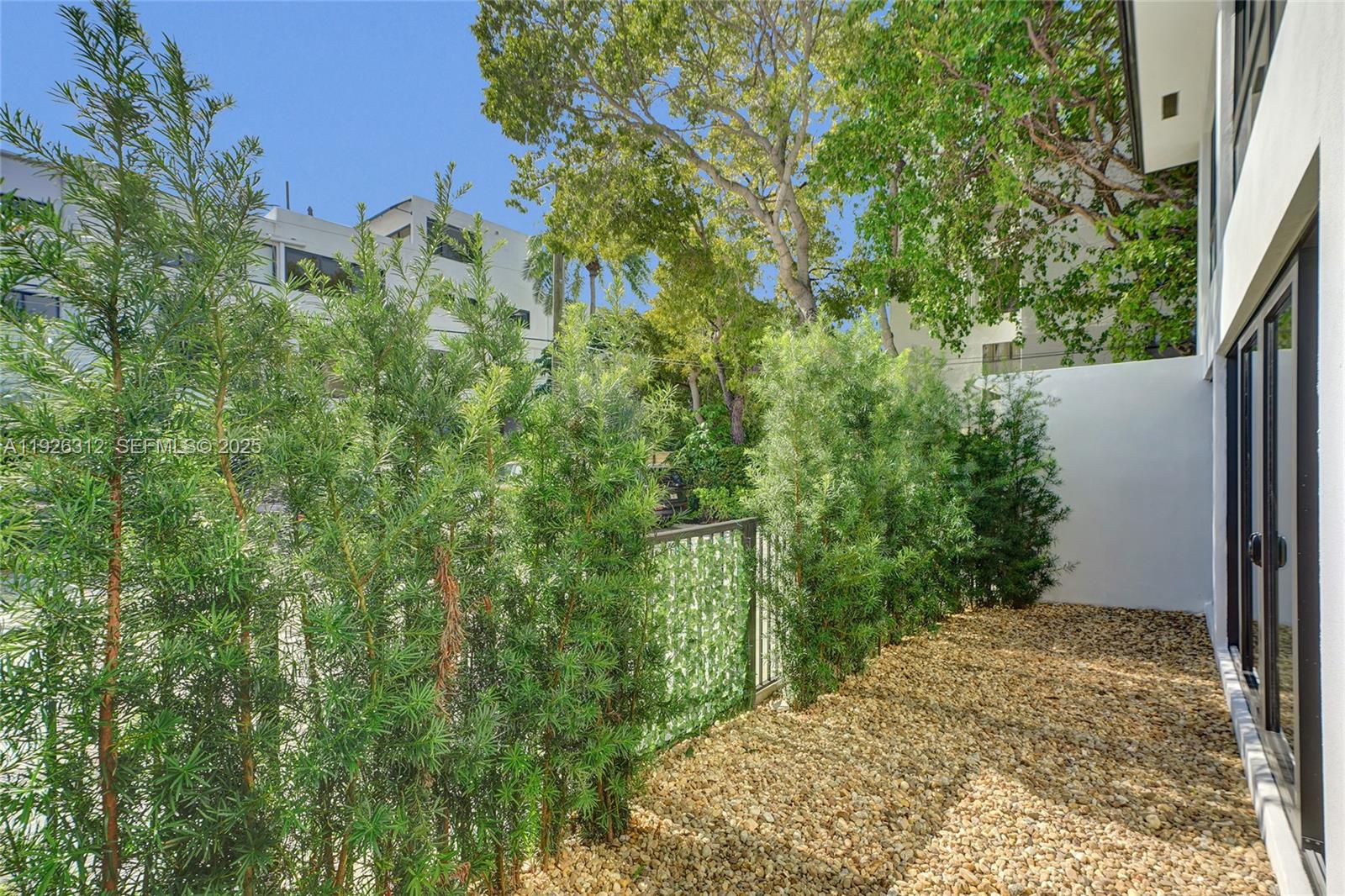 200 Sunrise Drive, Unit 200A Key Biscayne, FL 33149 - Photo 35 of 45 a view of a yard with plants and a large tree