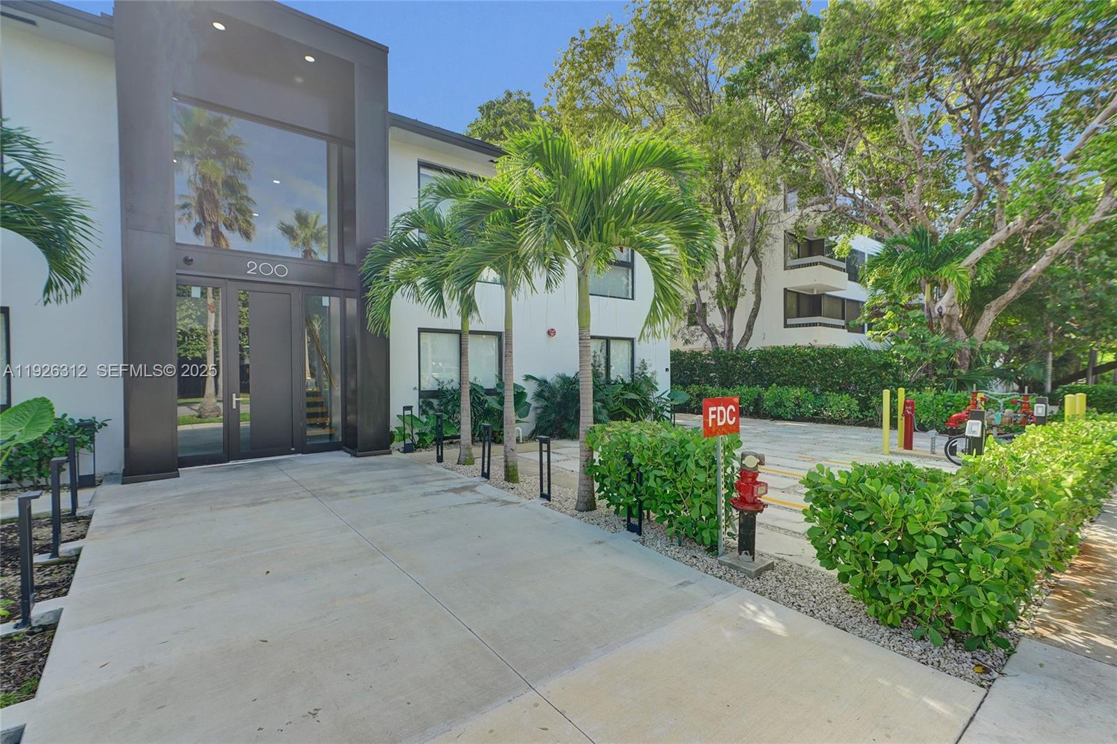 200 Sunrise Drive, Unit 200A Key Biscayne, FL 33149 - Photo 40 of 45 a front view of a house having yard