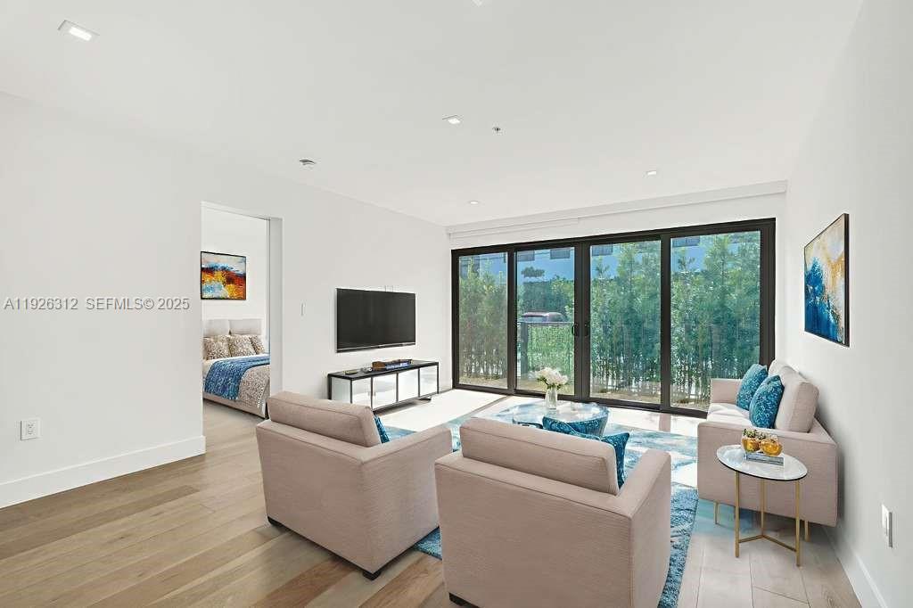 200 Sunrise Drive, Unit 200A Key Biscayne, FL 33149 - Photo 5 of 45 a living room with furniture and a large window