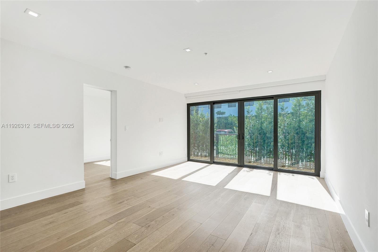 200 Sunrise Drive, Unit 200A Key Biscayne, FL 33149 - Photo 6 of 45 wooden floor in an empty room with a window