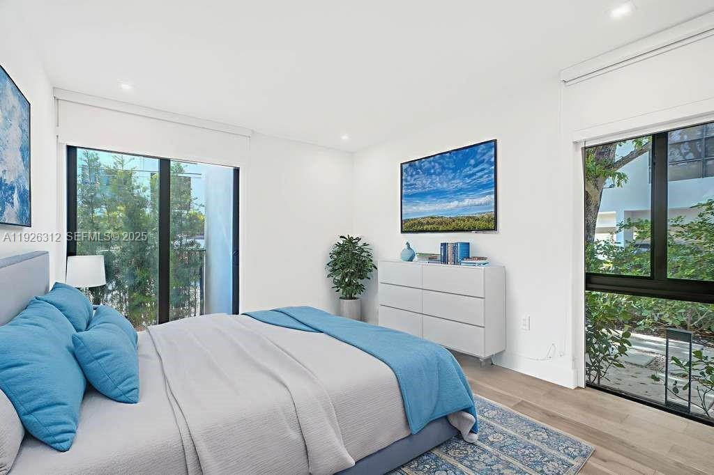 200 Sunrise Drive, Unit 200A Key Biscayne, FL 33149 - Photo 8 of 45 a bedroom with a large bed and a window