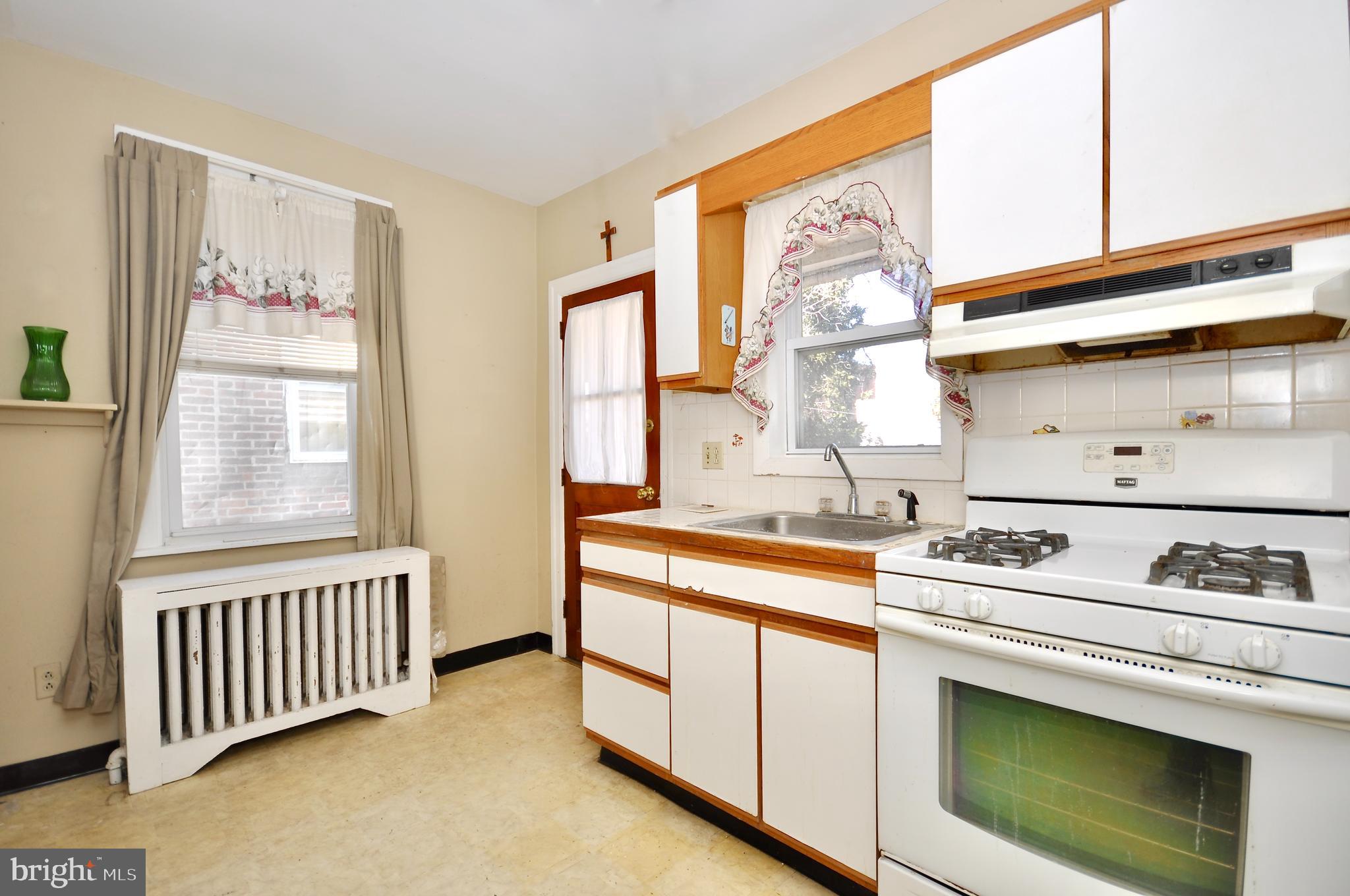 4566 Bermuda Street Philadelphia, PA 19124 - Photo 11 of 30 a kitchen with a stove and a window