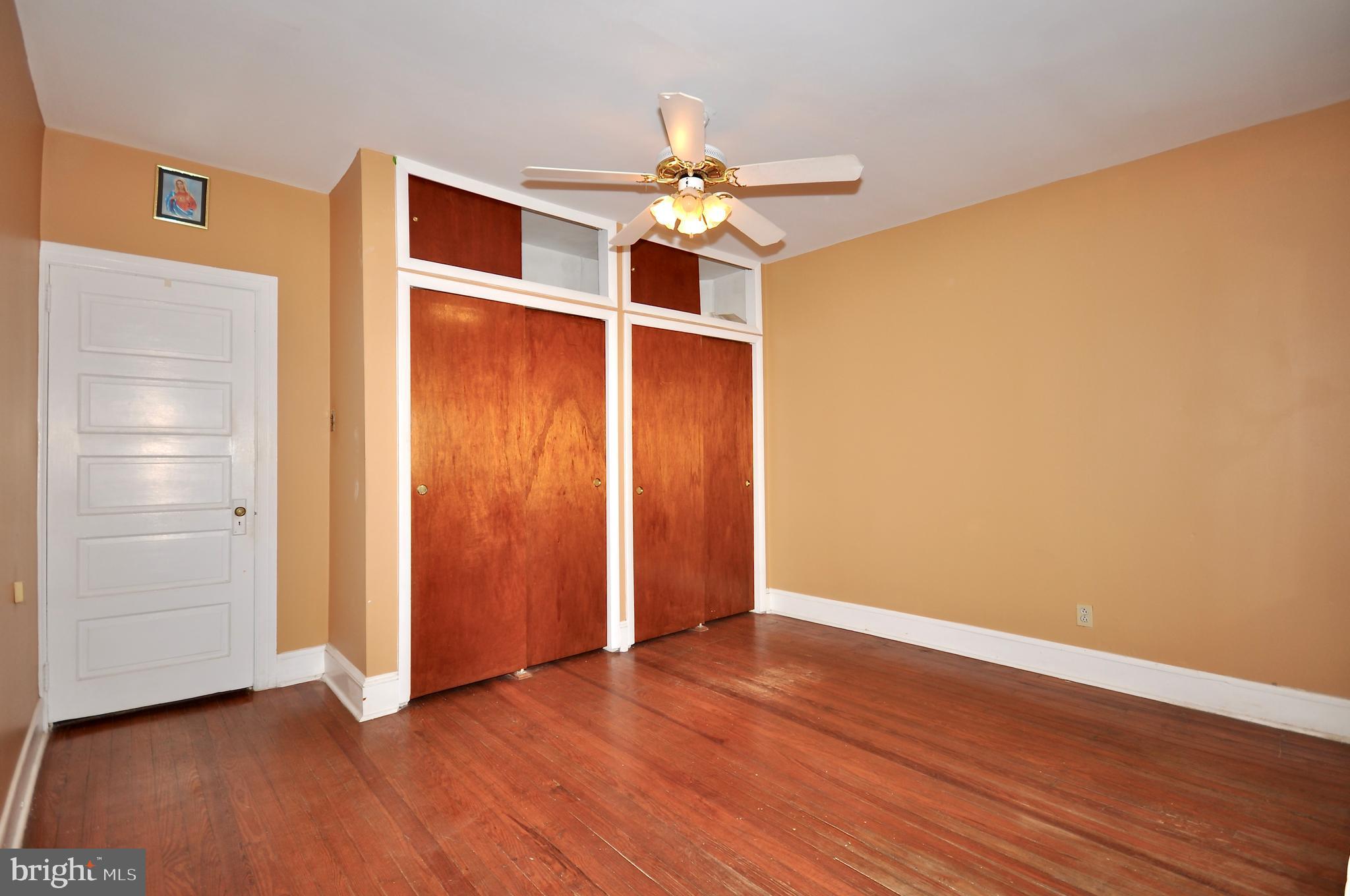 4566 Bermuda Street Philadelphia, PA 19124 - Photo 16 of 30 an empty room with wooden floor closet and windows