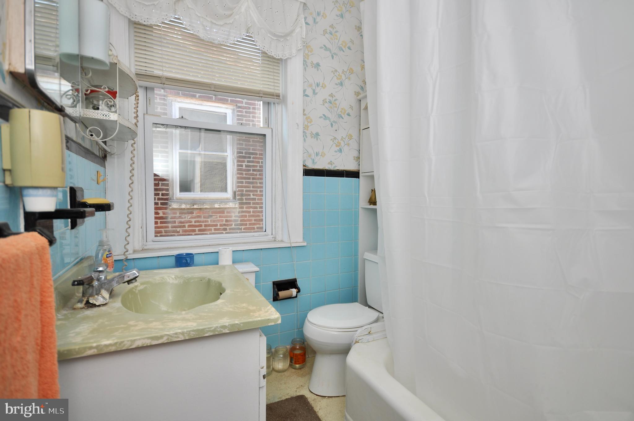 4566 Bermuda Street Philadelphia, PA 19124 - Photo 19 of 30 a bathroom with a granite countertop sink and a toilet