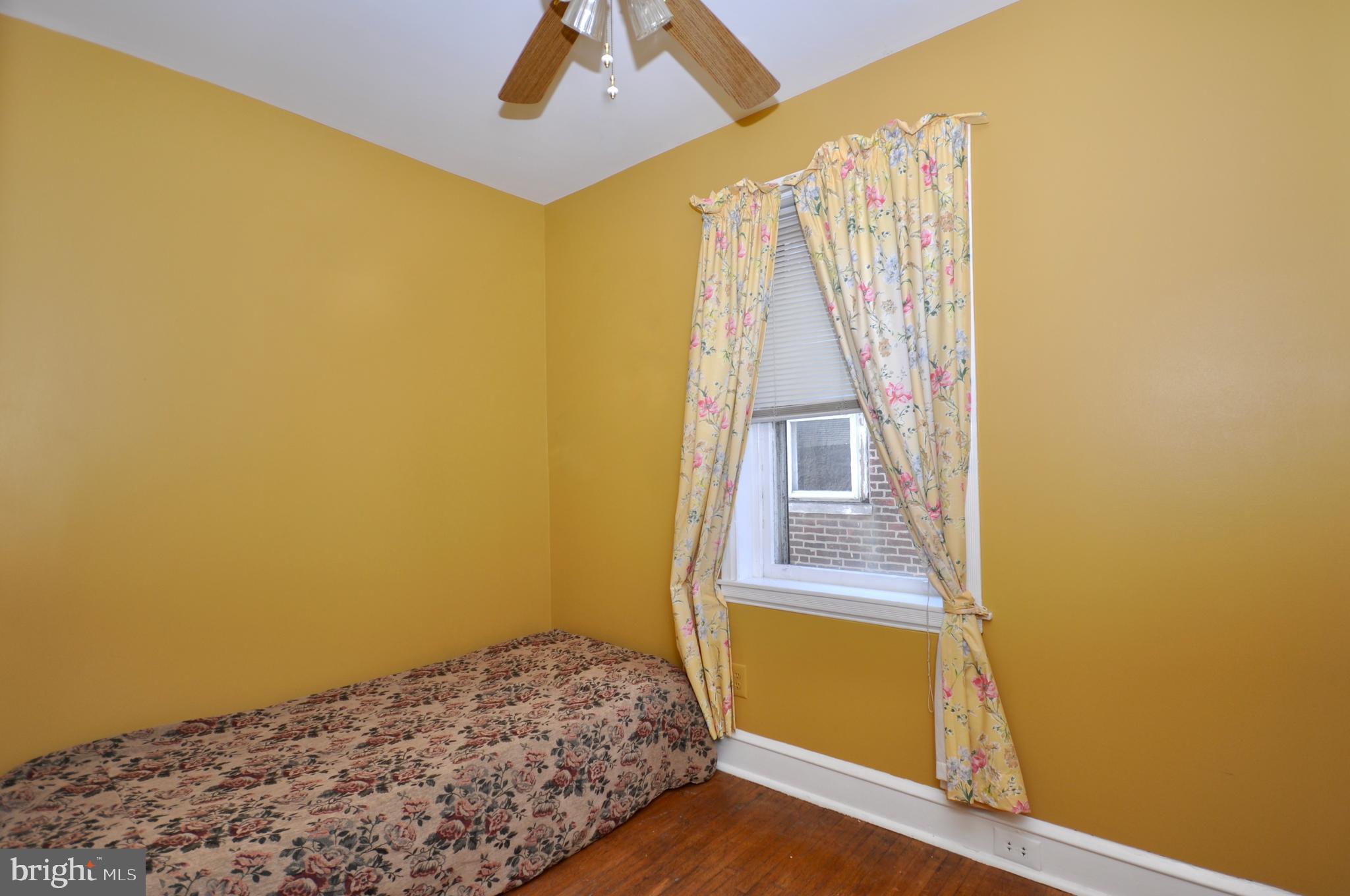 4566 Bermuda Street Philadelphia, PA 19124 - Photo 23 of 30 a bedroom with a bed and wooden floor