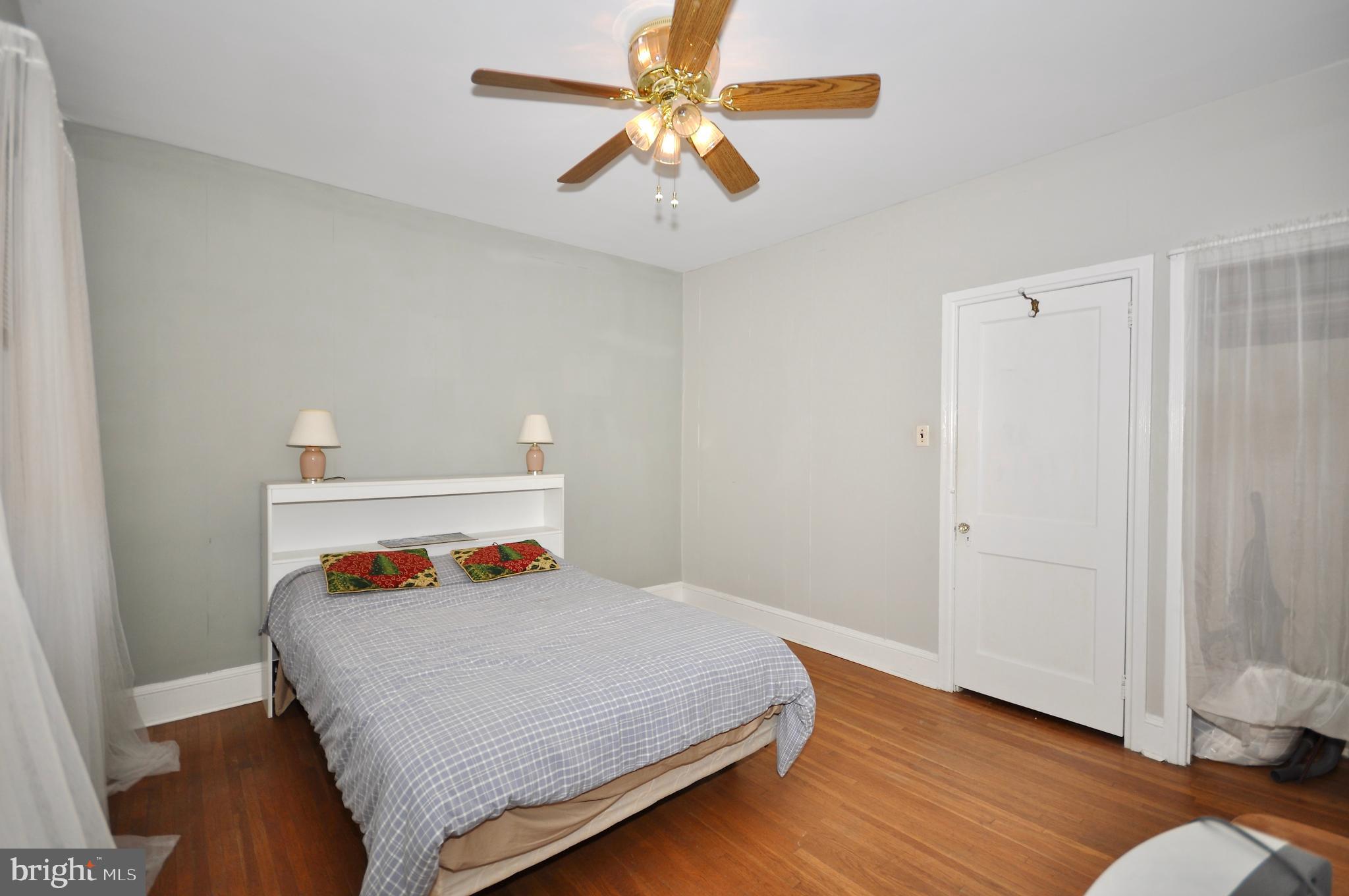 4566 Bermuda Street Philadelphia, PA 19124 - Photo 24 of 30 a bedroom with a bed and wooden floor