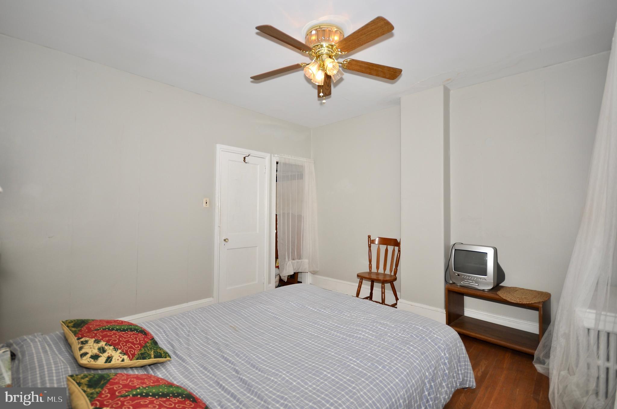4566 Bermuda Street Philadelphia, PA 19124 - Photo 25 of 30 a bedroom with a bed and a chandelier