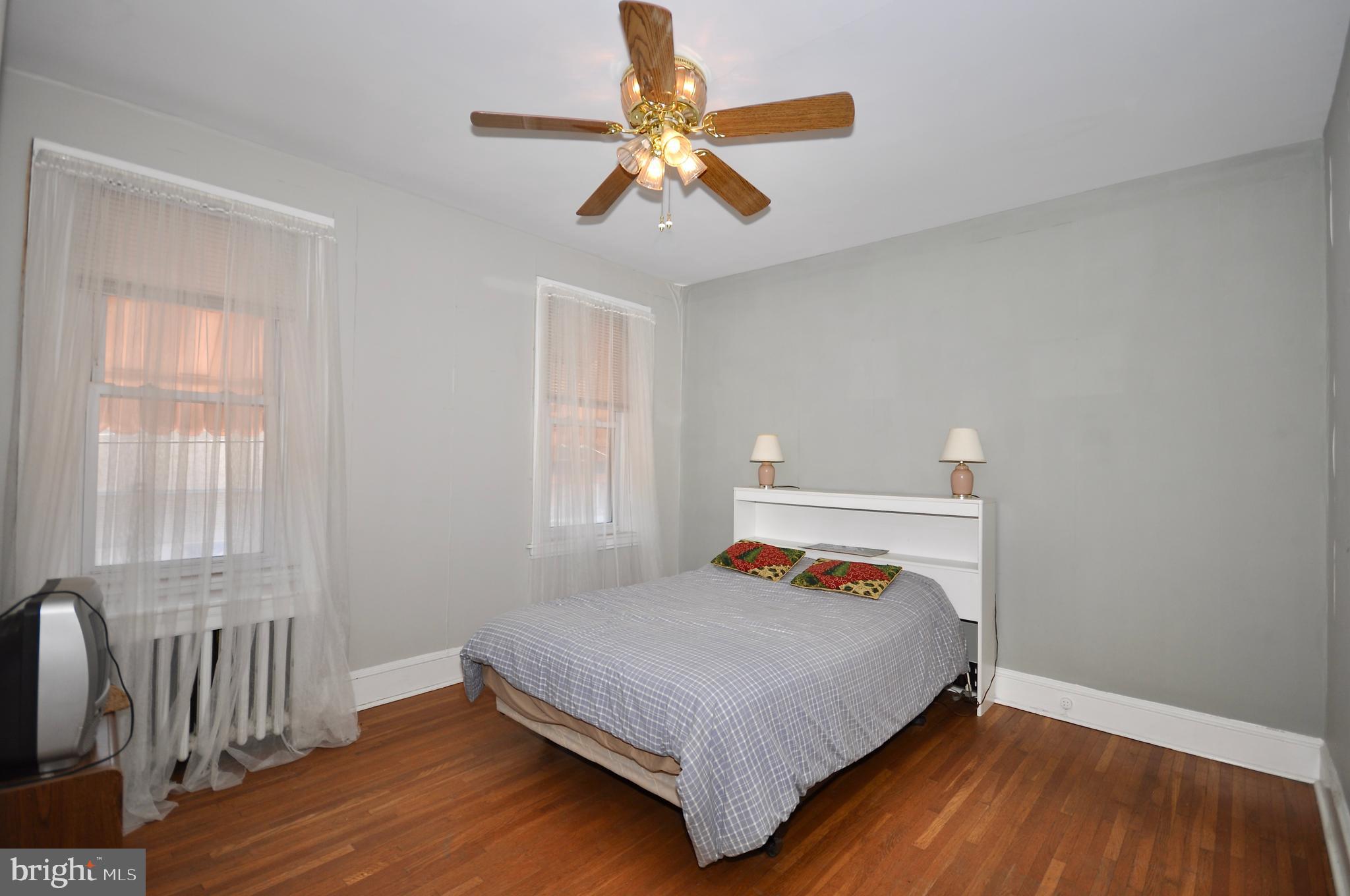 4566 Bermuda Street Philadelphia, PA 19124 - Photo 27 of 30 a bedroom with a bed and wooden floor