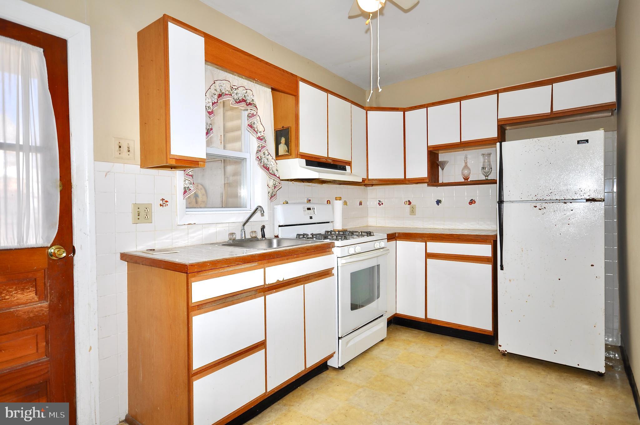 4566 Bermuda Street Philadelphia, PA 19124 - Photo 3 of 30 a kitchen with stainless steel appliances granite countertop cabinets and a refrigerator