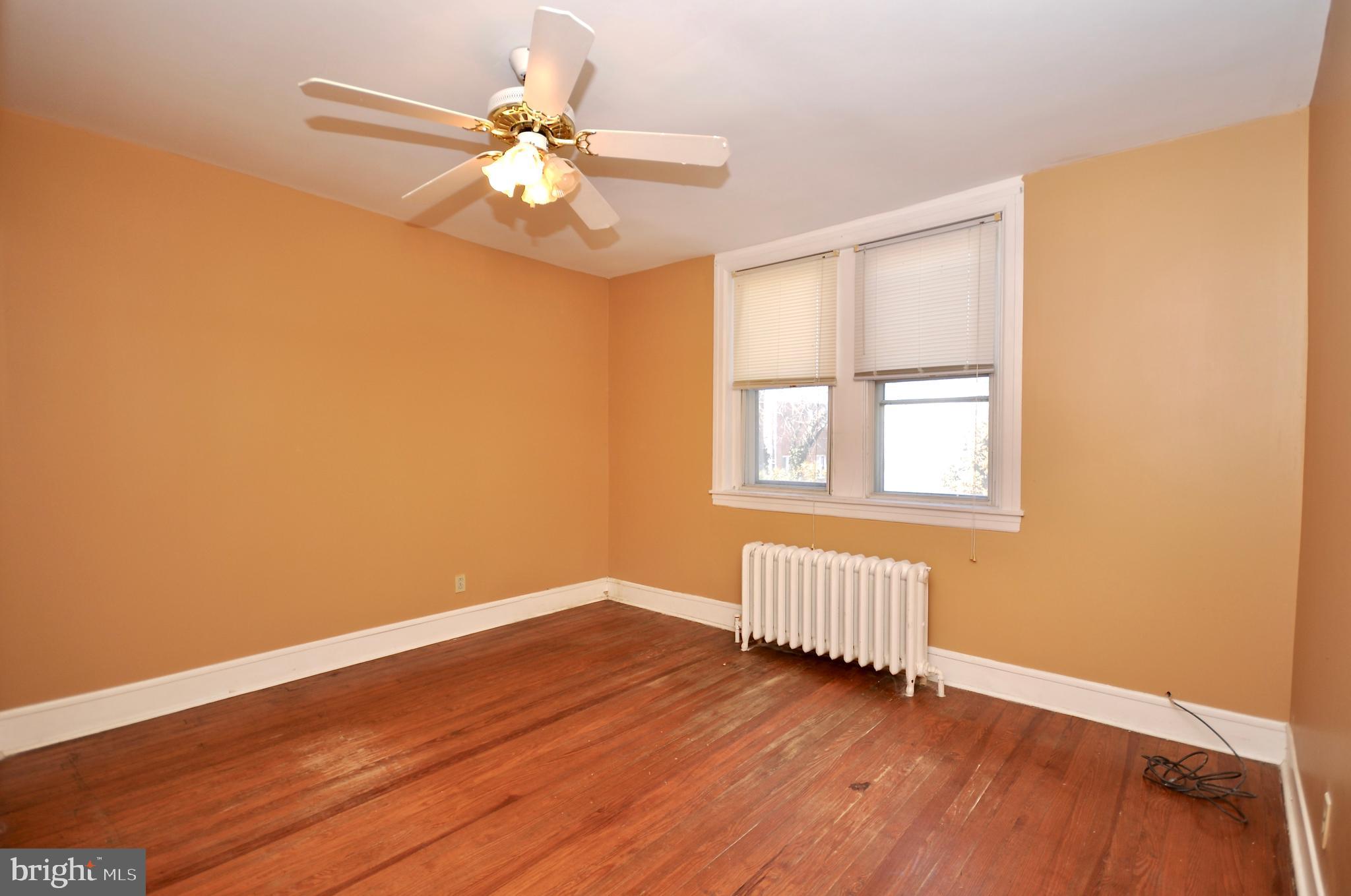 4566 Bermuda Street Philadelphia, PA 19124 - Photo 4 of 30 a view of an empty room with window and wooden floor