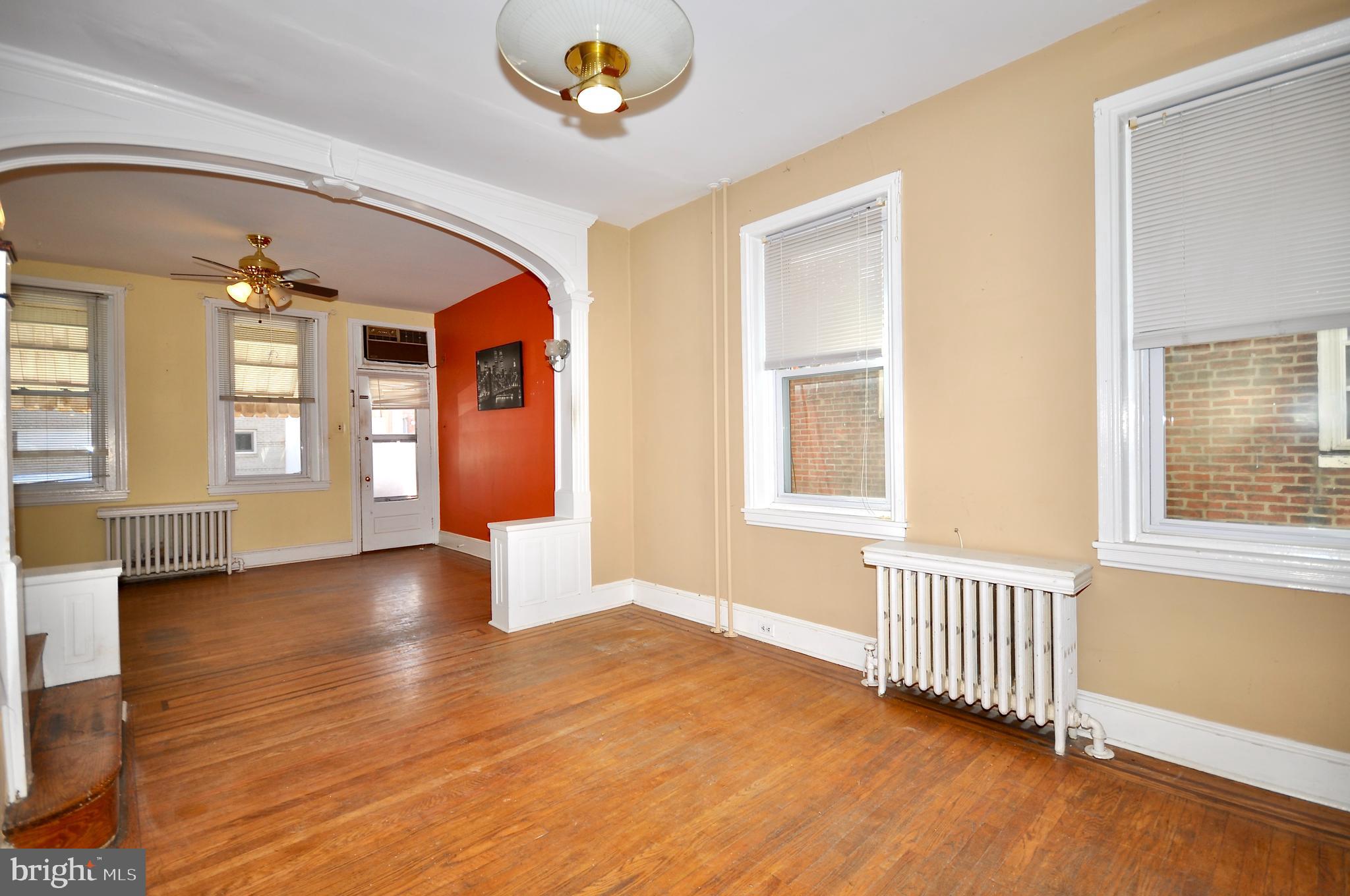 4566 Bermuda Street Philadelphia, PA 19124 - Photo 5 of 30 an empty room with wooden floor and windows