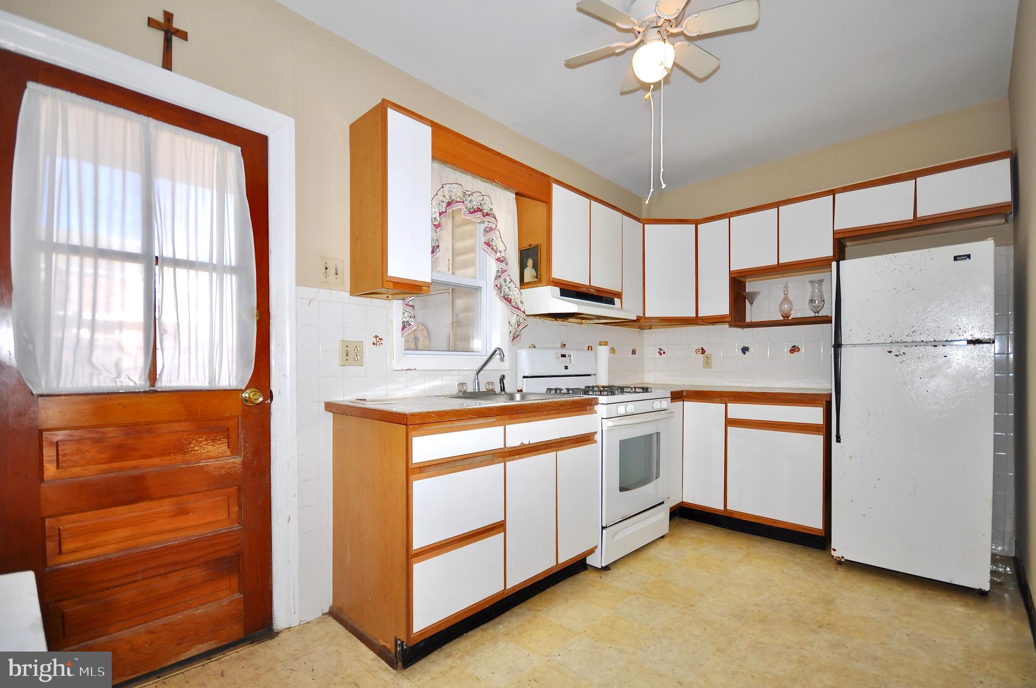 4566 Bermuda Street Philadelphia, PA 19124 - Photo 10 of 30 a kitchen with stainless steel appliances granite countertop a refrigerator and a sink