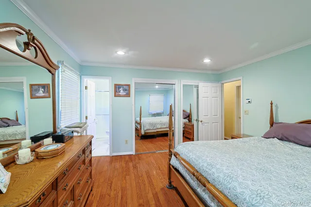 a bedroom with a bed and a large mirror