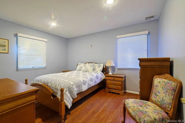 a bedroom with a bed and windows