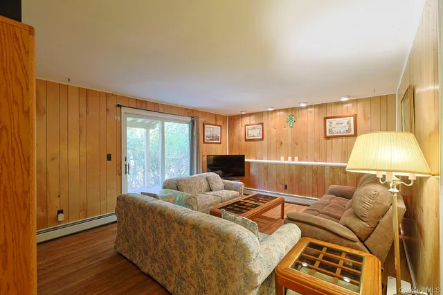 a living room with furniture and a lamp