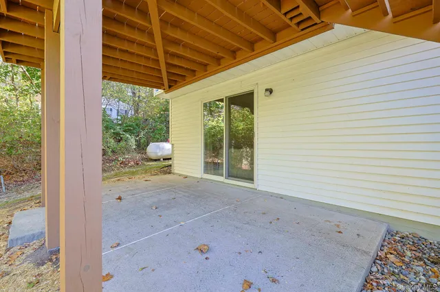 a view of a room with a ceiling fan and wooden floor