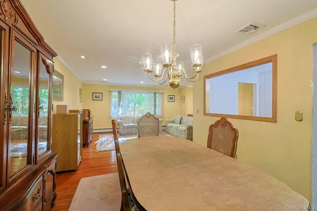 a spacious bedroom with bed and a chandelier