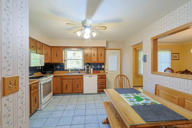 a kitchen with a refrigerator and a stove top oven