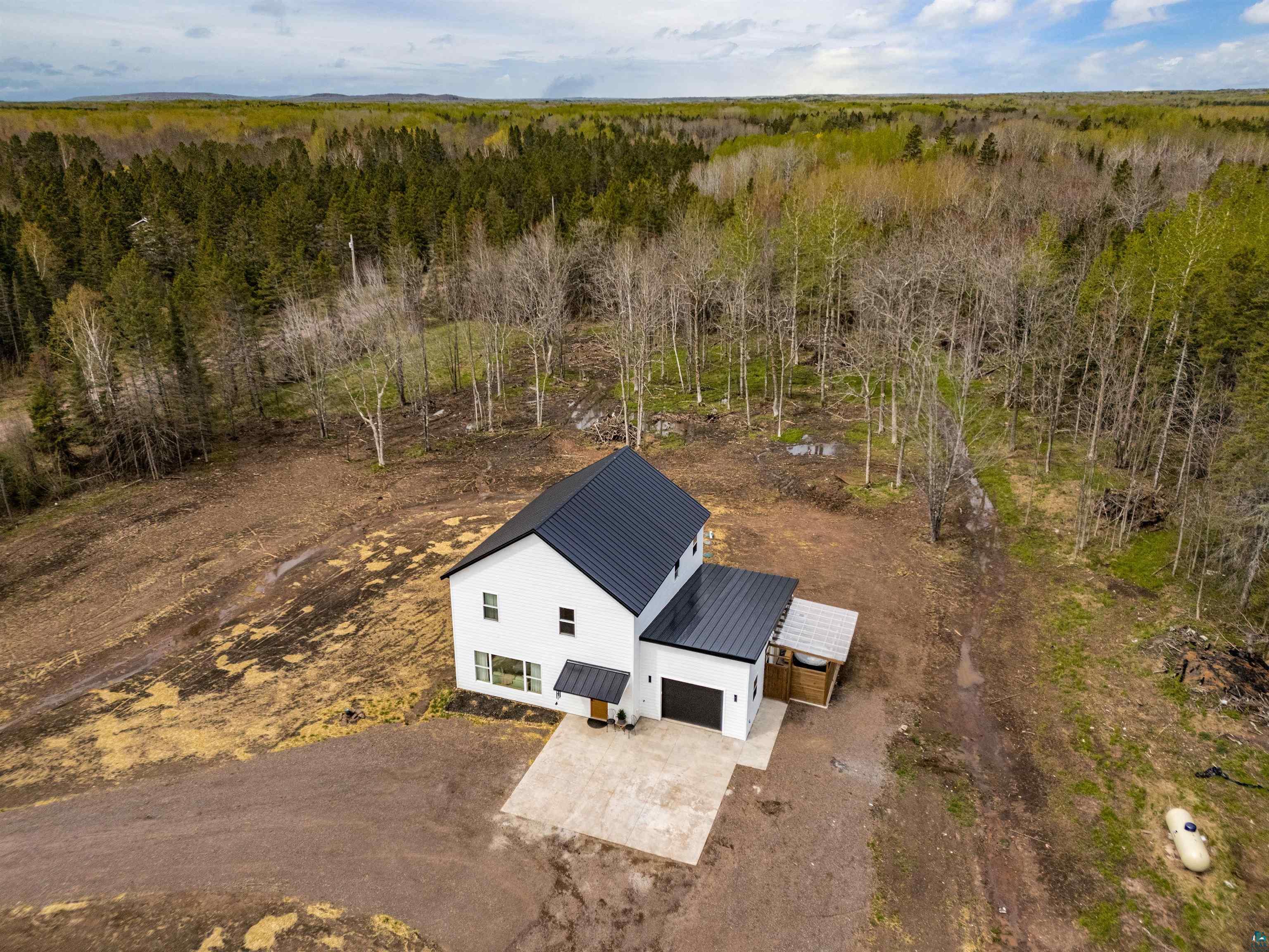 1825 East Shilhon Road Duluth, MN 55804 - Photo 2 of 37 3 year old Contemporary Traditional with a black metal roofs, white LP siding, attached garage, and a covered Pergola area off garage & access to sauna/spa area.