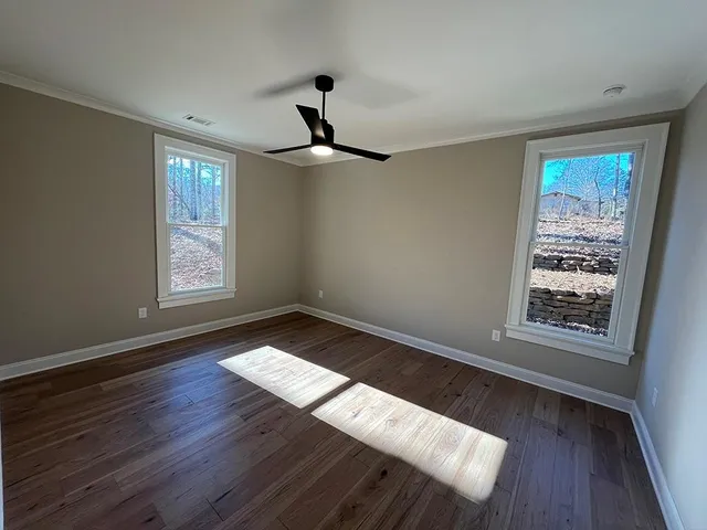 a view of wooden floor and windows in a room